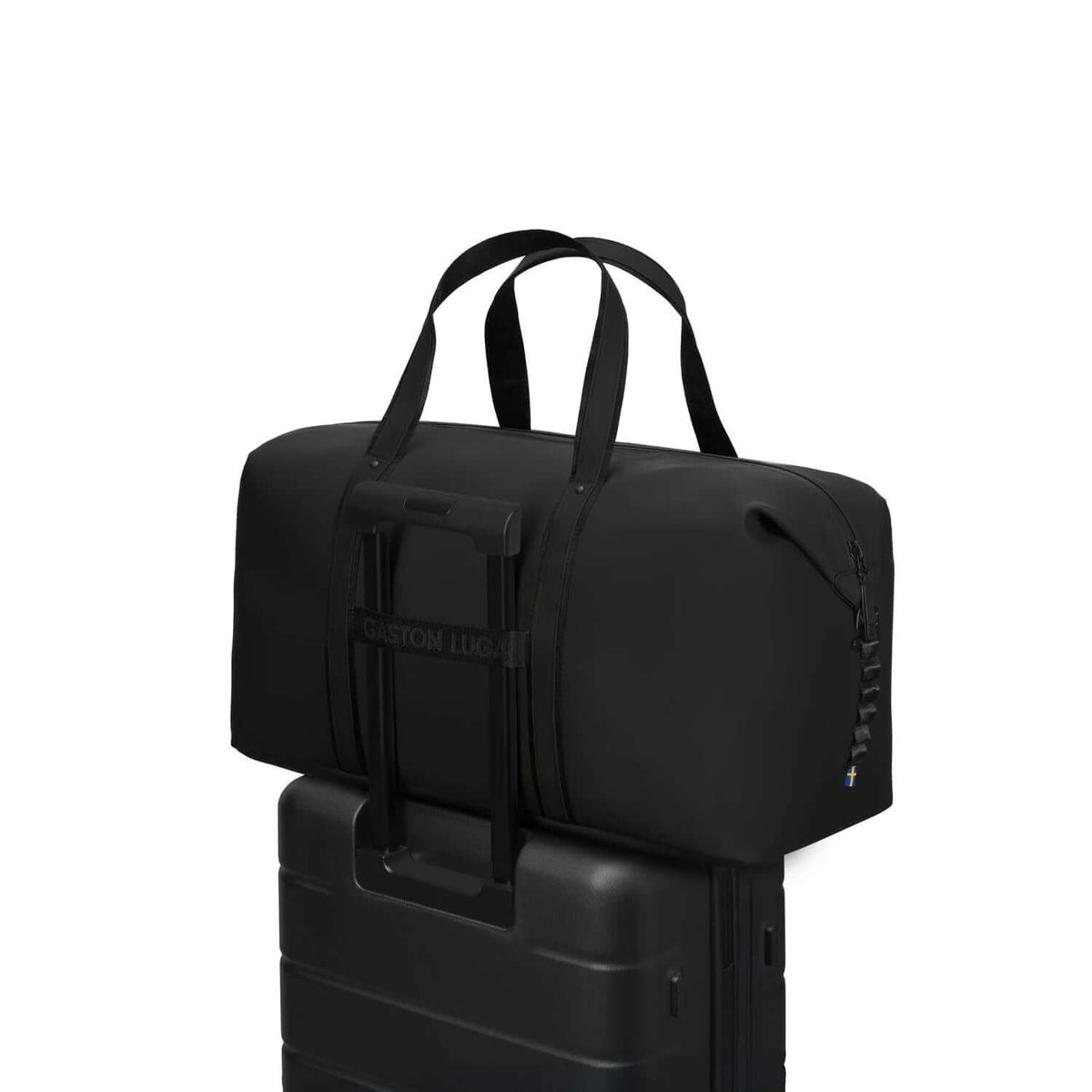 Gaston Luga Dash Weekender 2.0 Medium bag on top of a suitcase, ideal for travel as a corporate gift.