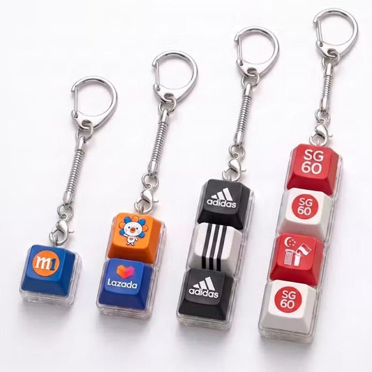 Four keycap keychains with one, two, three and four keys, showing example printed designs