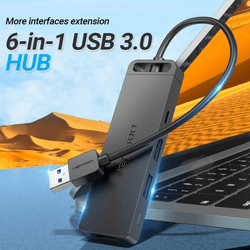 Vention 6-in-1 USB 3.0 Hub connecting to laptop, showcasing versatile connectivity and expansion.