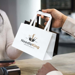 Small Flat Handle Paper Bag Landscape being handed over, ideal for corporate gifts and eco-friendly carry solutions.