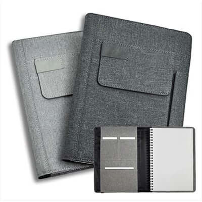 Light and dark grey A5 fabric notebooks with front pockets and an inset view of the wire-bound insert.