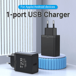 Vention 1-Port USB Wall Charger 12W on a table, ideal for charging Apple and Android devices efficiently.
