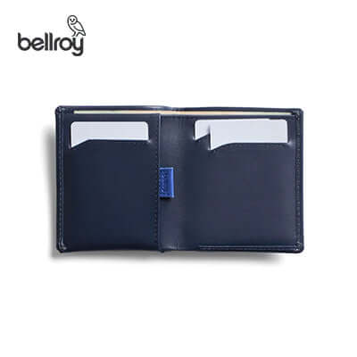 Open navy Bellroy Note Sleeve showing card slots and a blue pull tab.