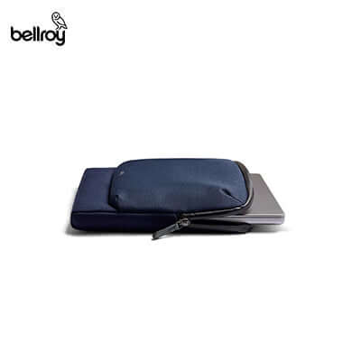Bellroy Laptop Caddy shown with a laptop partly inserted and accessories alongside.