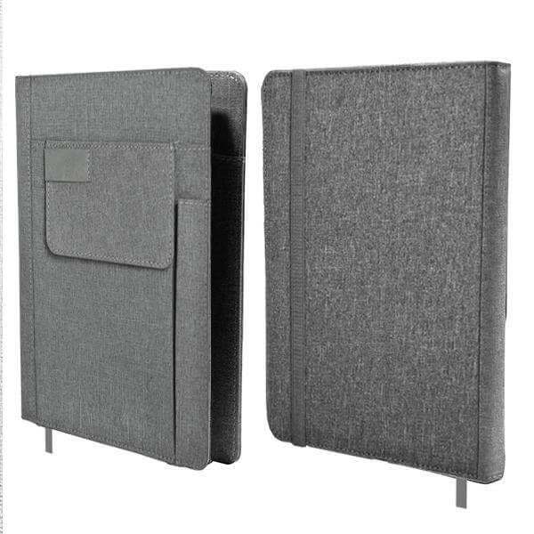 Front and back views of the light grey A5 fabric notebook with front pocket and pen slot.