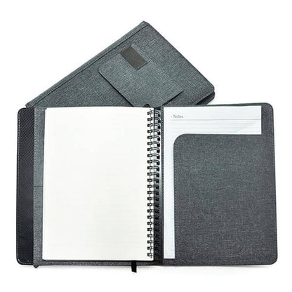 Grey fabric A5 notebook opened to the wire-bound insert and rear document pocket.