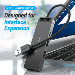 Vention 6-in-1 USB 2.0 Hub connected to a laptop for interface expansion and multipurpose connectivity.