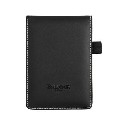 Black Balmain pocket notebook with contrasting stitching and a side pen loop.