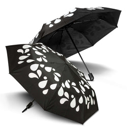 Colour Changing Compact Umbrella with black design and white droplets, ideal corporate gift in Singapore.