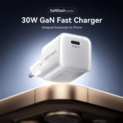 Vention 1-Port GaN Charger (30W) on a surface with a smartphone, showcasing fast charging features.
