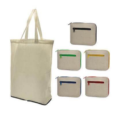 Natural-coloured cotton tote shown open and folded into compact zippered pouches with black, green, yellow, blue and red trim