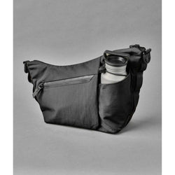 ALPAKA Flow Satchel Sling Bag with integrated bottle sleeve for hydration and organized storage