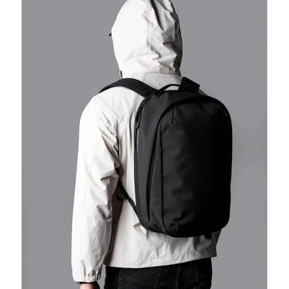 ALPAKA Metro Backpack Pro worn by a person in a light jacket, showcasing its sleek design and functionality.