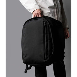 Person holding the ALPAKA Metro Backpack Pro in black for modern professionals, ideal as a corporate gift.