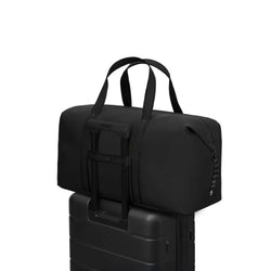Gaston Luga Dash Weekender 2.0 Medium bag on top of a suitcase, ideal for travel as a corporate gift.