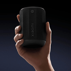 Xiaomi Bluetooth Speaker Mini held in hand, showcasing its compact design and portability for music lovers.